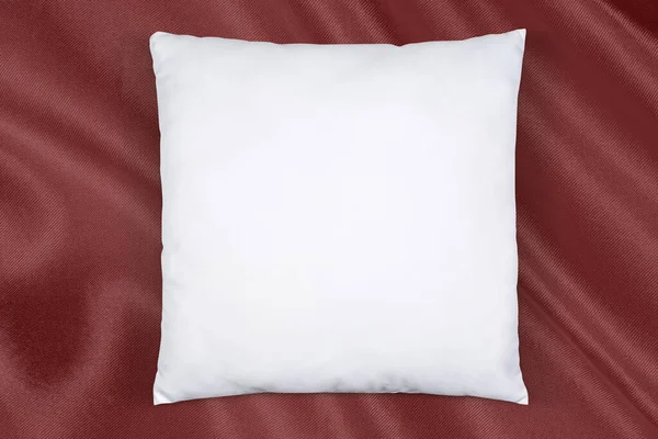 White Pillow Lying Lazily Atop Cheerful Red Silk — Stockfoto