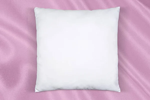 White Square Pillow Enjoying Nap Atop Soft Flowing Pink Silk — Stockfoto