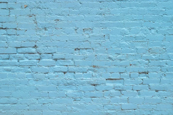 Closeup of weathered painted blue wall.