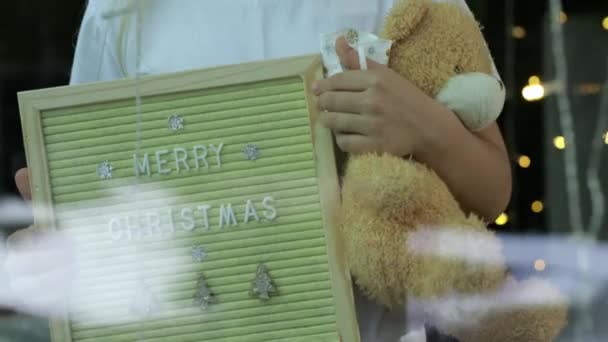 Girl Holding Holiday Wooden Frame Teddy Bear Home Christmas Time — Stock Video