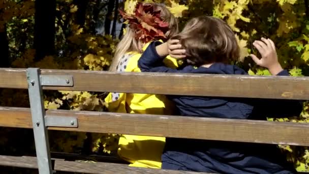 Two Kids Sitting Resting Wooden Bench Autumn Park — Video Stock