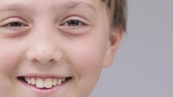 Caucasian boy of 9 years smiles in a tender manner. — Vídeo de stock