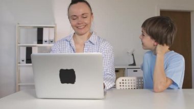Boy is making a surprise to his mother.