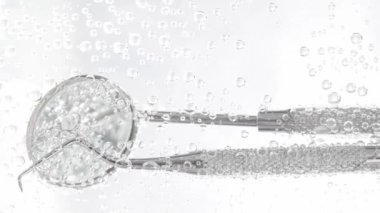 Dental kit in a sparkling water. Closeup. Slow motion. High quality 4k footage