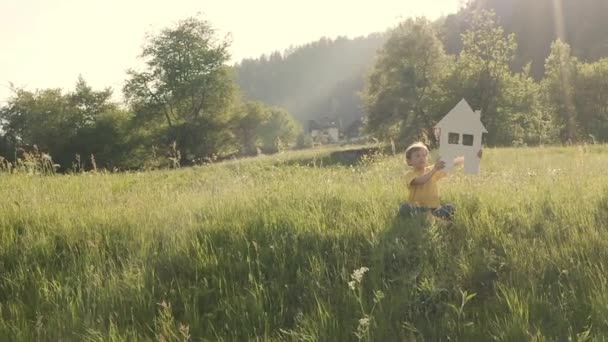 Boy Keeping House Wind Turbine Slow Motion — 图库视频影像