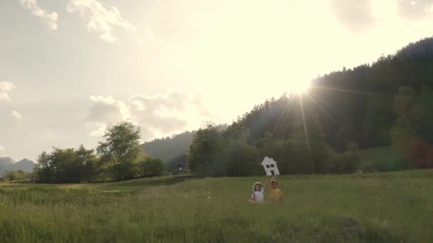 Sister Brother Keeping Paper House Mini Wind Turbine Slow Motion — Vídeos de Stock