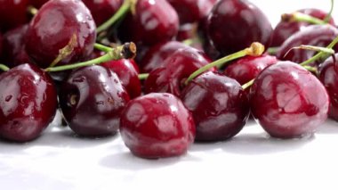 Sweet red cherries are being sprayed by water. High quality 4k footage