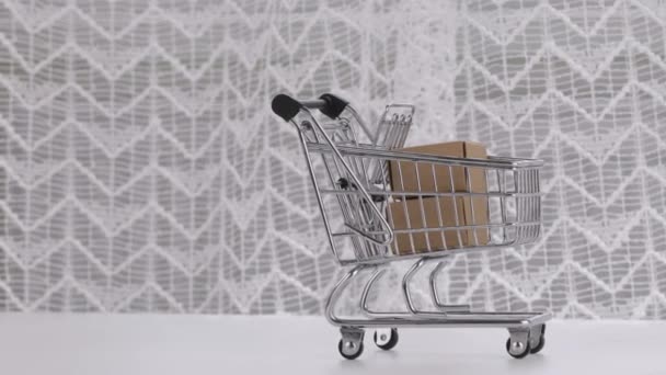 Mini Shopping Cart Small Carton Boxes White Table Negative Space — Wideo stockowe