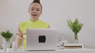 Young female coach is giving online consultation. 