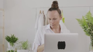 Young fashion designer gives online consultation. 
