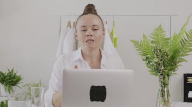 Young fashion designer gives online consultation. 