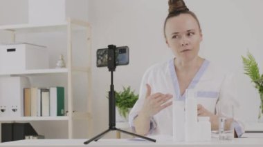 Female cosmetologist is giving online consultation. 