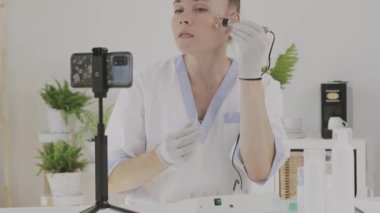 Female cosmetologist is giving online consultation. 