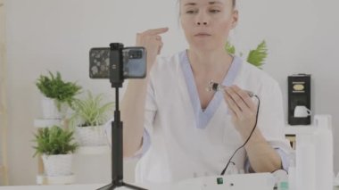 Female cosmetologist is giving online consultation. 
