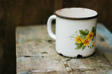 empty white cup with flower, tea, mug and flowers, on a wooden table, vintage style.
