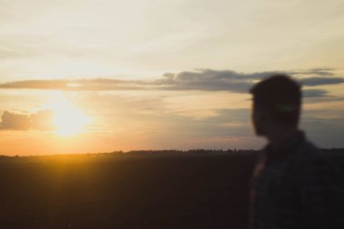 person watching sunseta man looks at the sunset