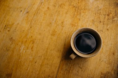 a cup of coffee on the tablemorning cup of coffee on an old tablecolored cup