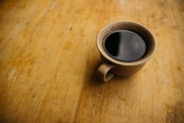 a cup of coffee on the tablemorning cup of coffee on an old tablecolored cup