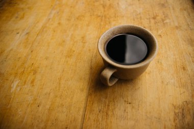 a cup of coffee on the tablemorning cup of coffee on an old tablecolored cup