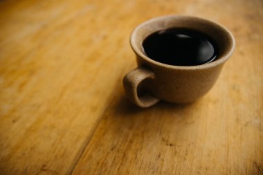 a cup of coffee on the tablemorning cup of coffee on an old tablecolored cup
