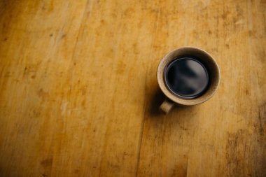 a cup of coffee on the tablemorning cup of coffee on an old tablecolored cup