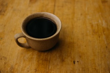 a cup of coffee on the tablemorning cup of coffee on an old tablecolored cup