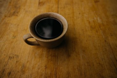 a cup of coffee on the tablemorning cup of coffee on an old tablecolored cup