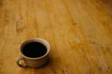 a cup of coffee on the tablemorning cup of coffee on an old tablecolored cup