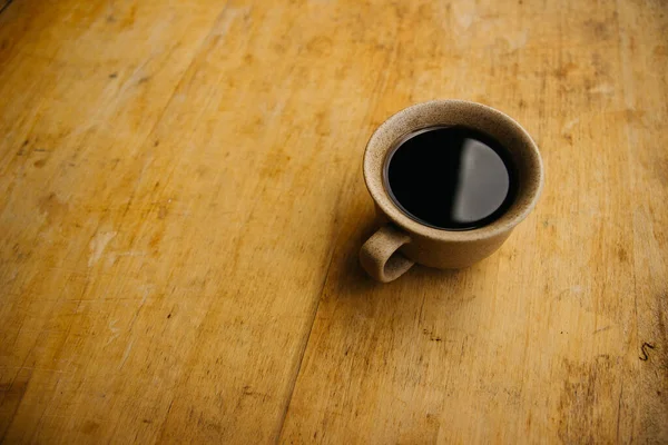 a cup of coffee on the tablemorning cup of coffee on an old tablecolored cup