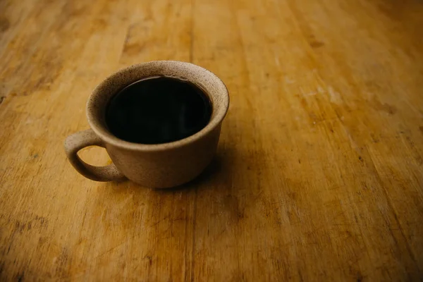 a cup of coffee on the tablemorning cup of coffee on an old tablecolored cup