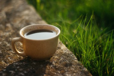a cup of coffee on the background of the sunset.cup of coffee in the sunset