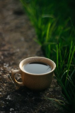 a cup of coffee on the background of the sunset.cup of coffee in the sunset