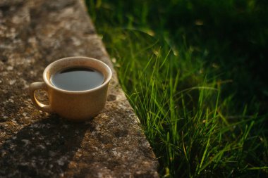 a cup of coffee on the background of the sunset.cup of coffee in the sunset