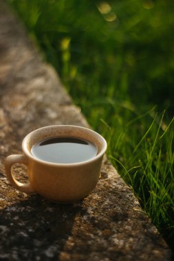 a cup of coffee on the background of the sunset.cup of coffee in the sunset