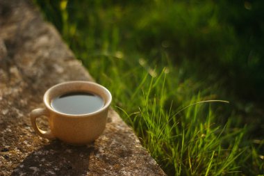 a cup of coffee on the background of the sunset.cup of coffee in the sunset