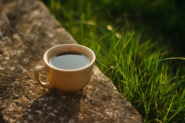 a cup of coffee on the background of the sunset.cup of coffee in the sunset