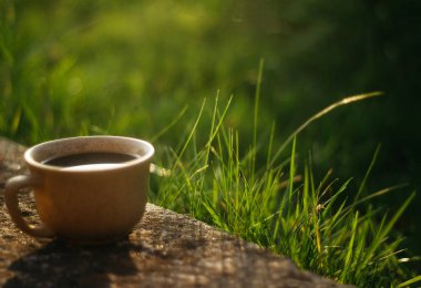 a cup of coffee on the background of the sunset.cup of coffee in the sunset