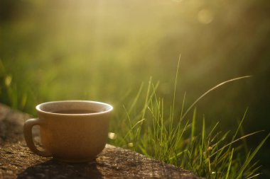 a cup of coffee on the background of the sunset.cup of coffee in the sunset