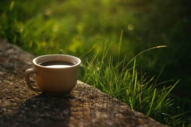 a cup of coffee on the background of the sunset.cup of coffee in the sunset