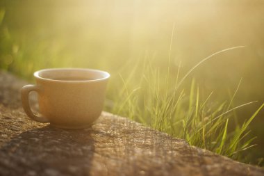 a cup of coffee on the background of the sunset.cup of coffee in the sunset