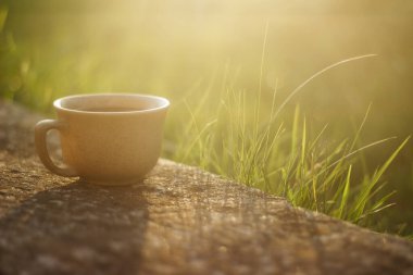 a cup of coffee on the background of the sunset.cup of coffee in the sunset