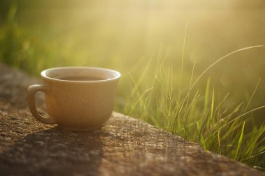 a cup of coffee on the background of the sunset.cup of coffee in the sunset