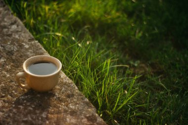 a cup of coffee on the background of the sunset.cup of coffee in the sunset