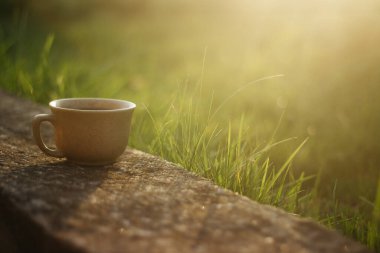 a cup of coffee on the background of the sunset.cup of coffee in the sunset