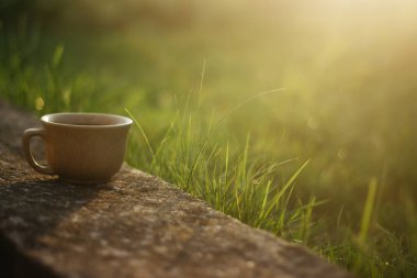 a cup of coffee on the background of the sunset.cup of coffee in the sunset