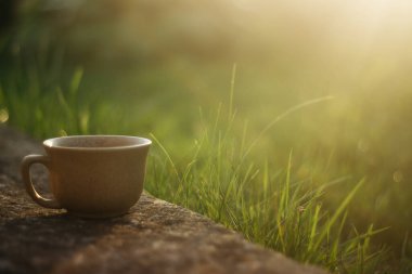 a cup of coffee on the background of the sunset.cup of coffee in the sunset