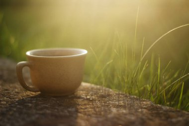 a cup of coffee on the background of the sunset.cup of coffee in the sunset
