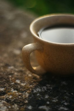 a cup of coffee on the background of the sunset.cup of coffee in the sunset