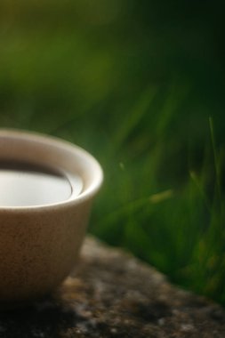 a cup of coffee on the background of the sunset.cup of coffee in the sunset