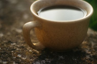 a cup of coffee on the background of the sunset.cup of coffee in the sunset